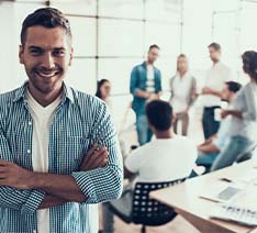 Man smiling in front of group